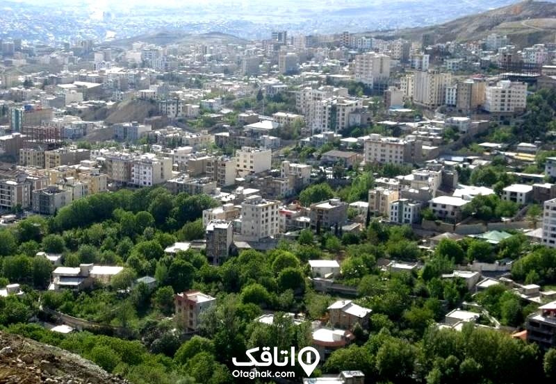 نمایی بالا از یک شهر و درختان در میان اپارتمان و خیابان ها