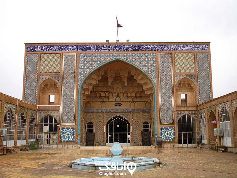 مسجدی با ورودی تزییین شده با کتشی های آبی رنگ و طرح حای اسلیمی ، یک حوض وسط حیاط